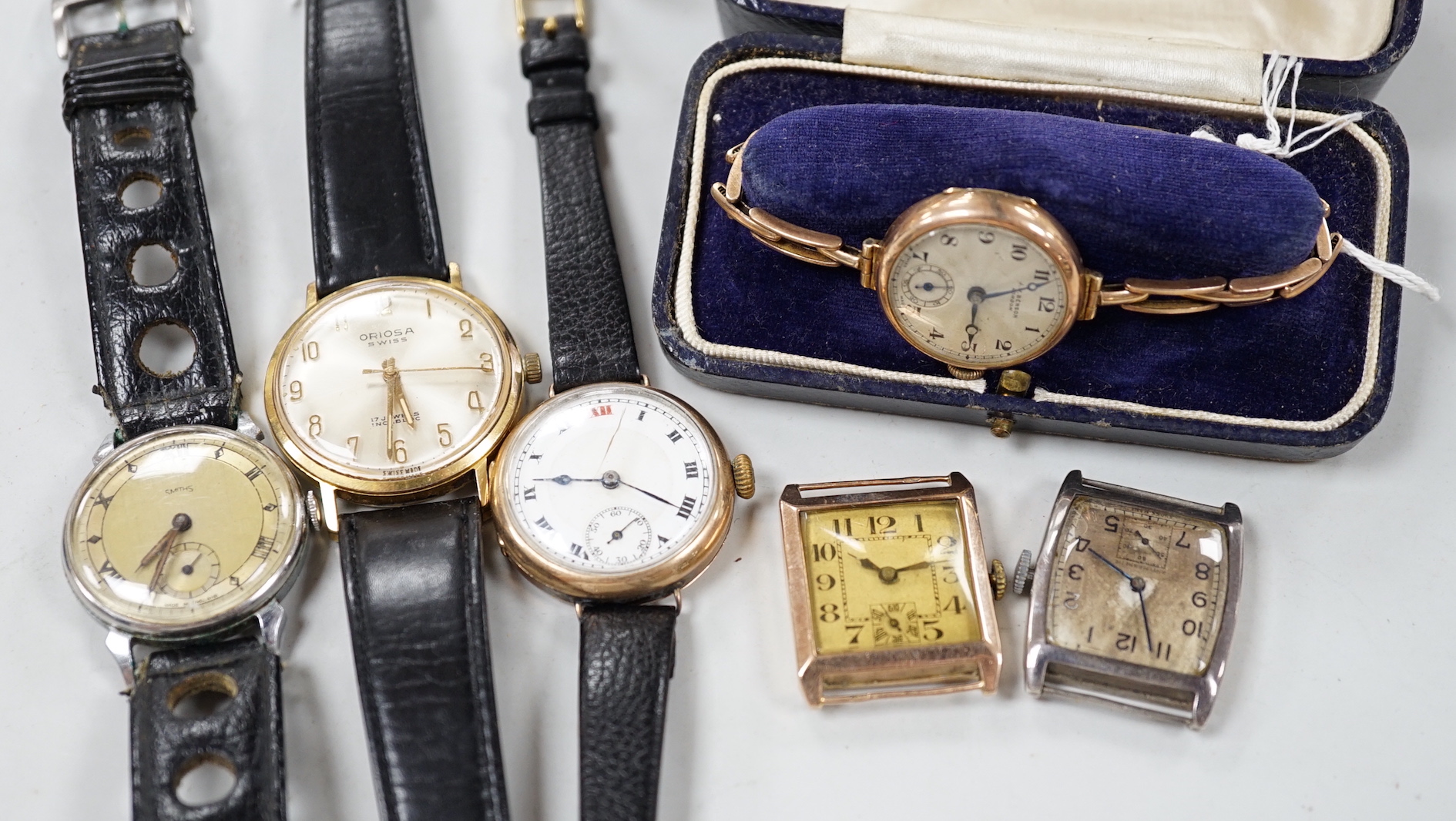 A lady's 1930's 9k J.W. Benson manual wind wrist watch, on a 9ct flexible bracelet, one other gentleman's 9ct gold wrist watch and four other wrist watches.